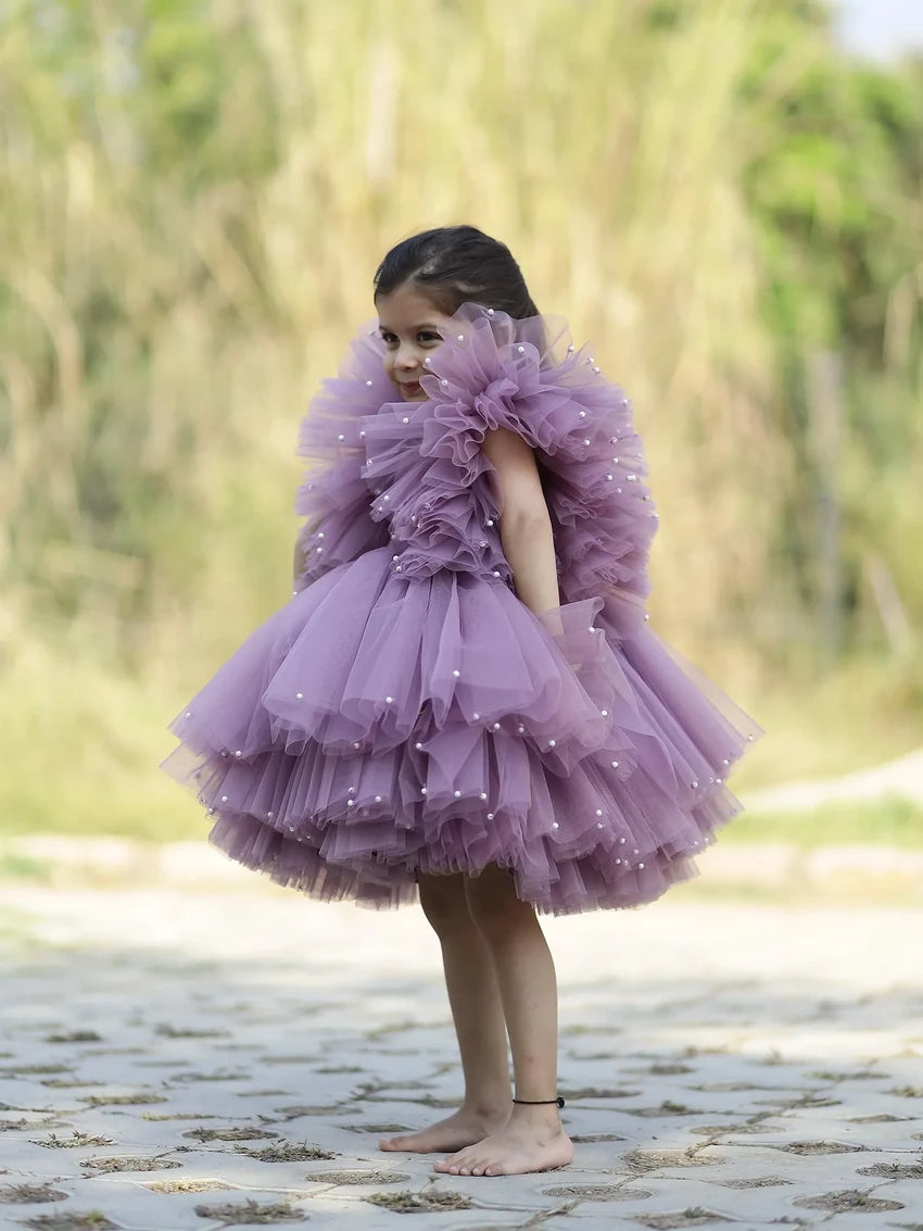 side view of lavender pearl-embellished puffy tulle gown for flower girls.