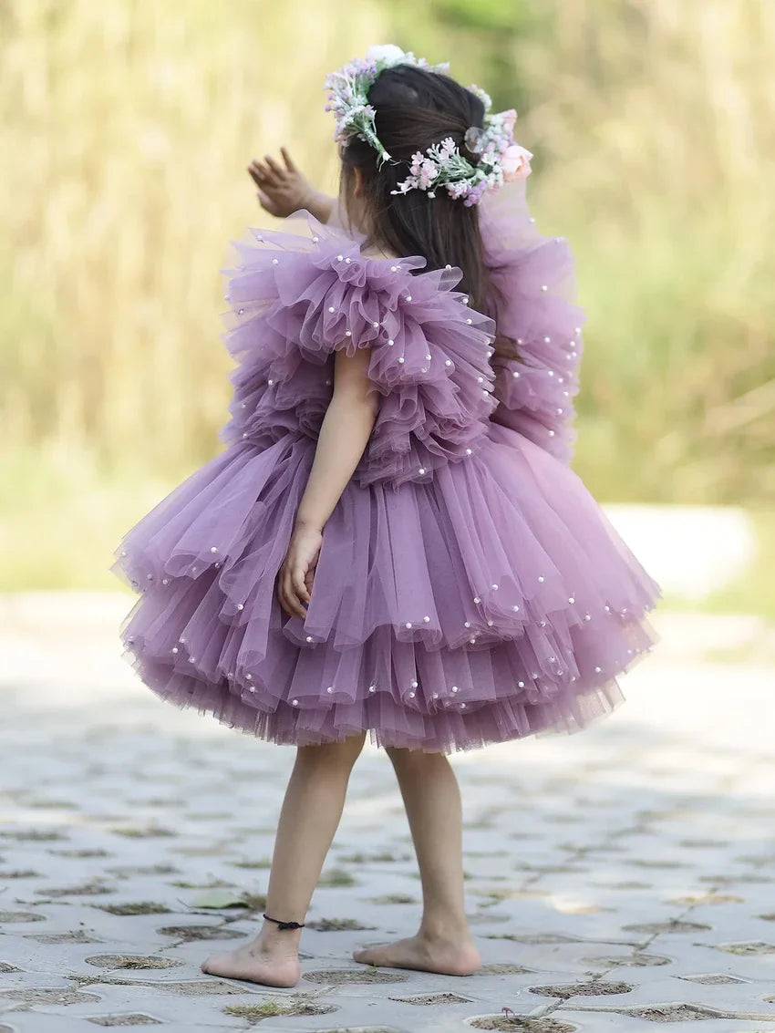 Back view of elegant lavender tulle gown with pearl details for special occasions.