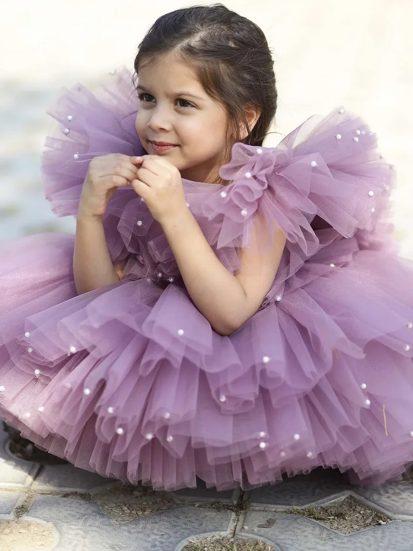 Close-up of pearl embellishments on lavender tulle flower girl dress.