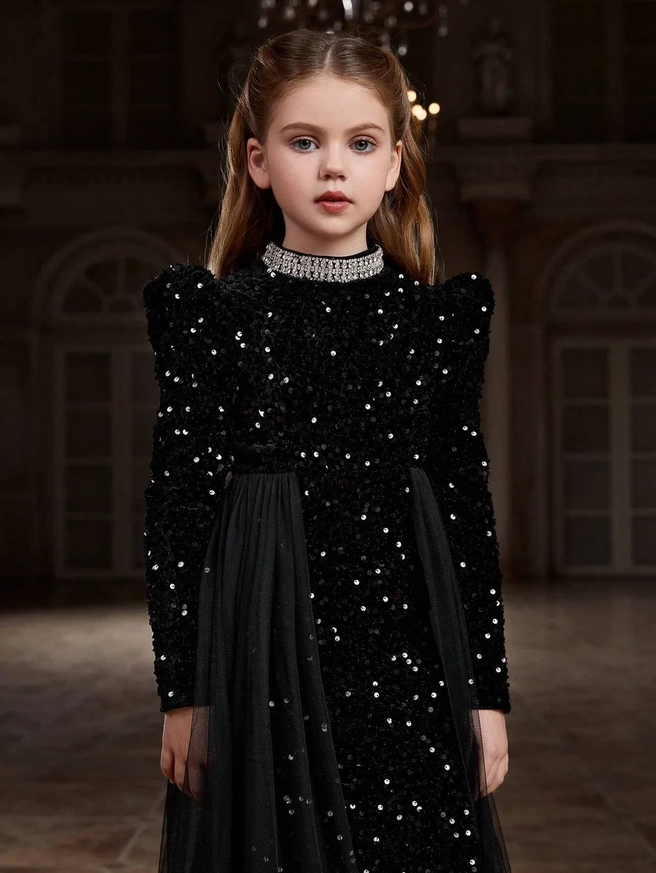 Close-up of black velvet dress bodice featuring sparkling accents and soft, luxurious velvet fabric.