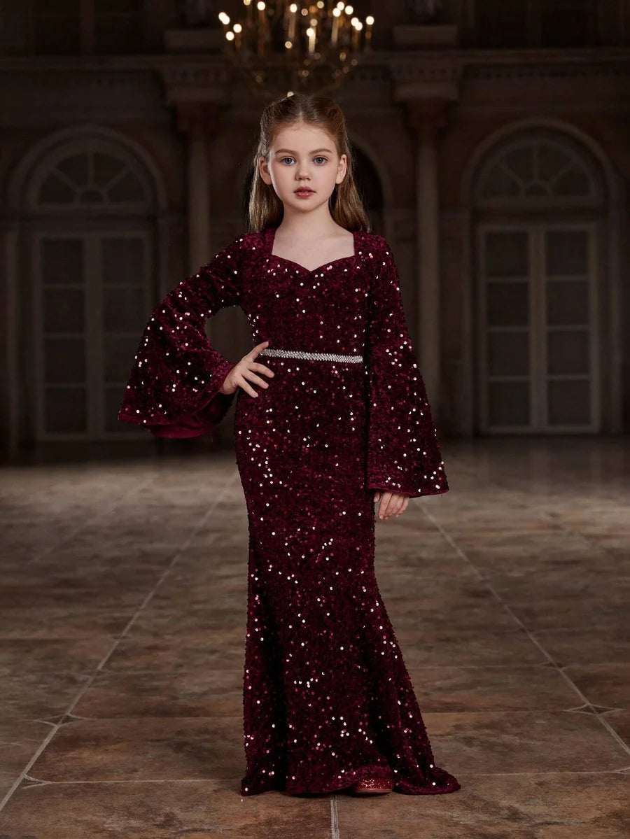 Styled image of the red shimmering velvet girls mermaid dress paired with matching accessories, perfect for special occasions.