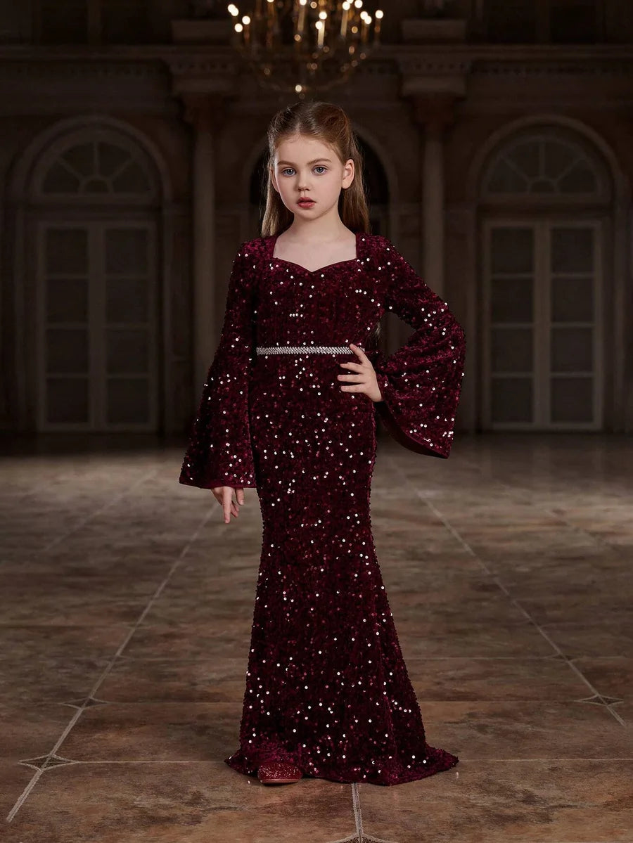 Front view of the red shimmering velvet girls mermaid dress, showcasing the fitted bodice and stunning flared hem.