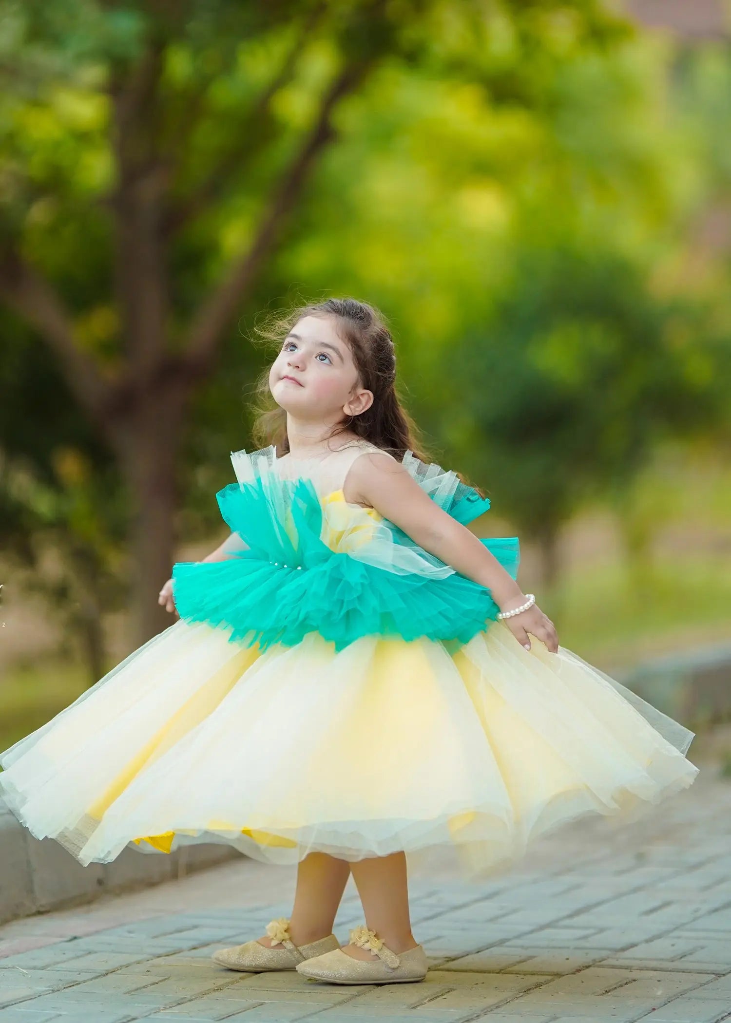 Side view of princess-style Girls' Tulle Party Dress in green and yellow