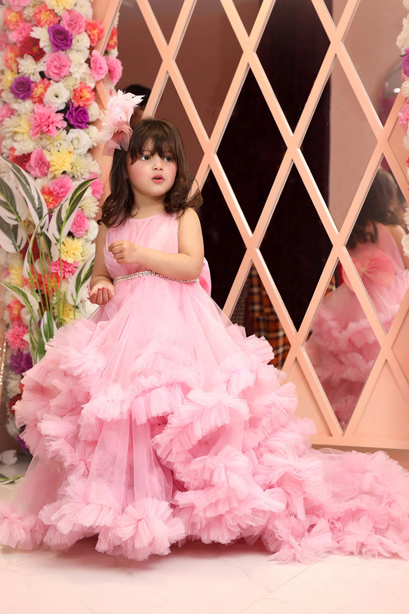 Front view of Ruffled Train Dress in baby pink – luxury pink ruffled gown for girls