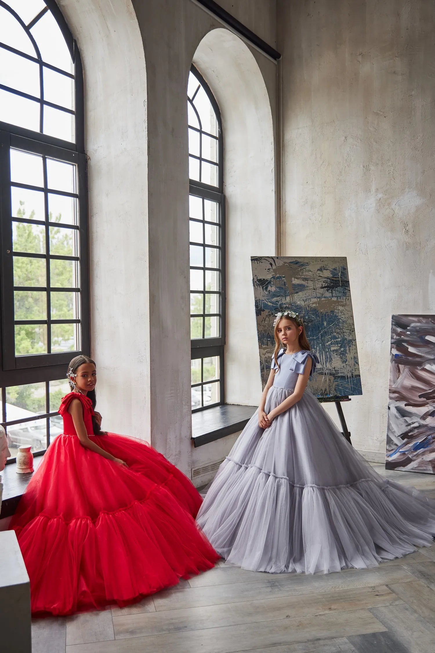 Full view of Ruby Reverie red flower girl dress, showcasing its flowing silhouette and luxurious design