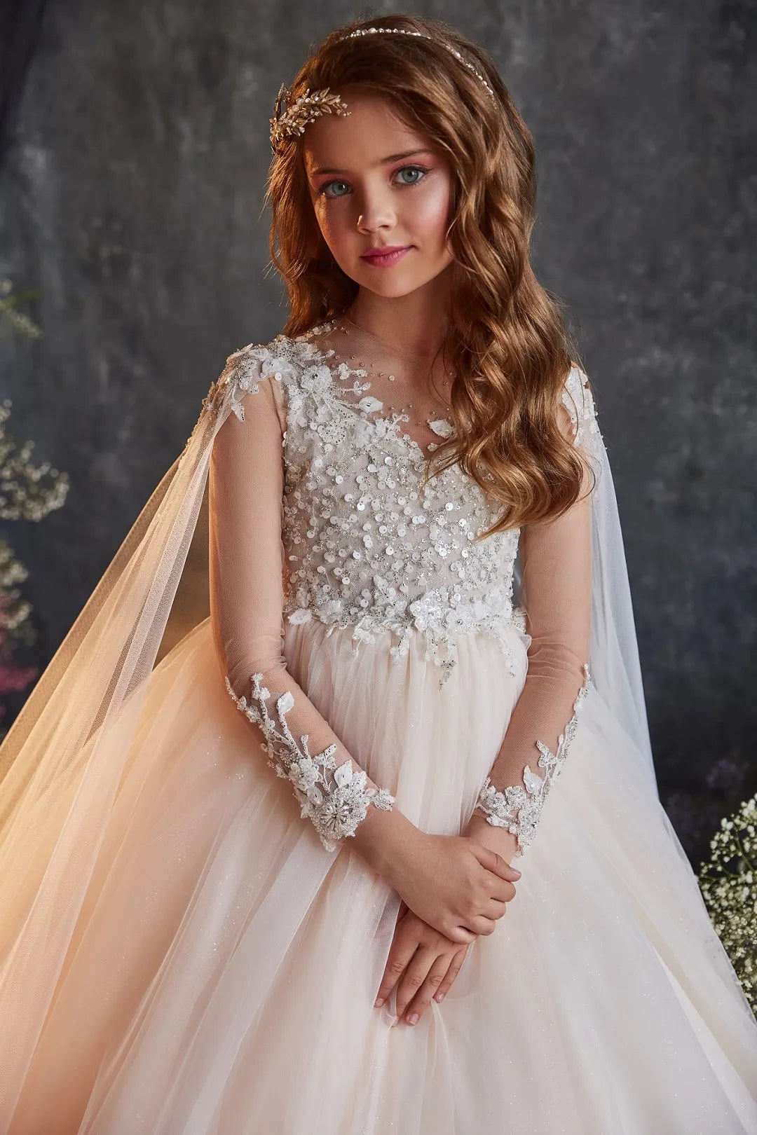 Close-up of embellished bodice with lace and sequin details on ivory flower girl gown