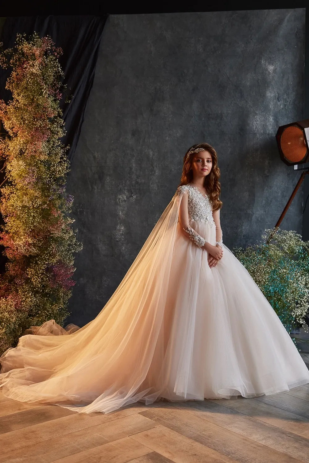 Front view of ivory embellished flower girl gown with lace and train