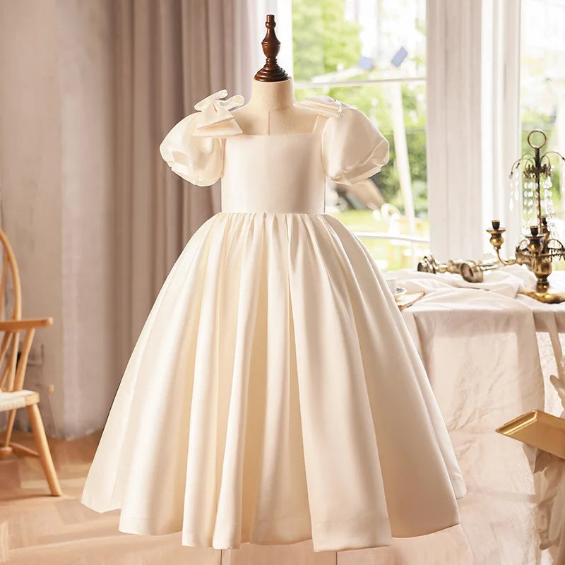 Front view of an ivory satin puff sleeve girls' ball gown, featuring elegant puff sleeves and a classic silhouette.