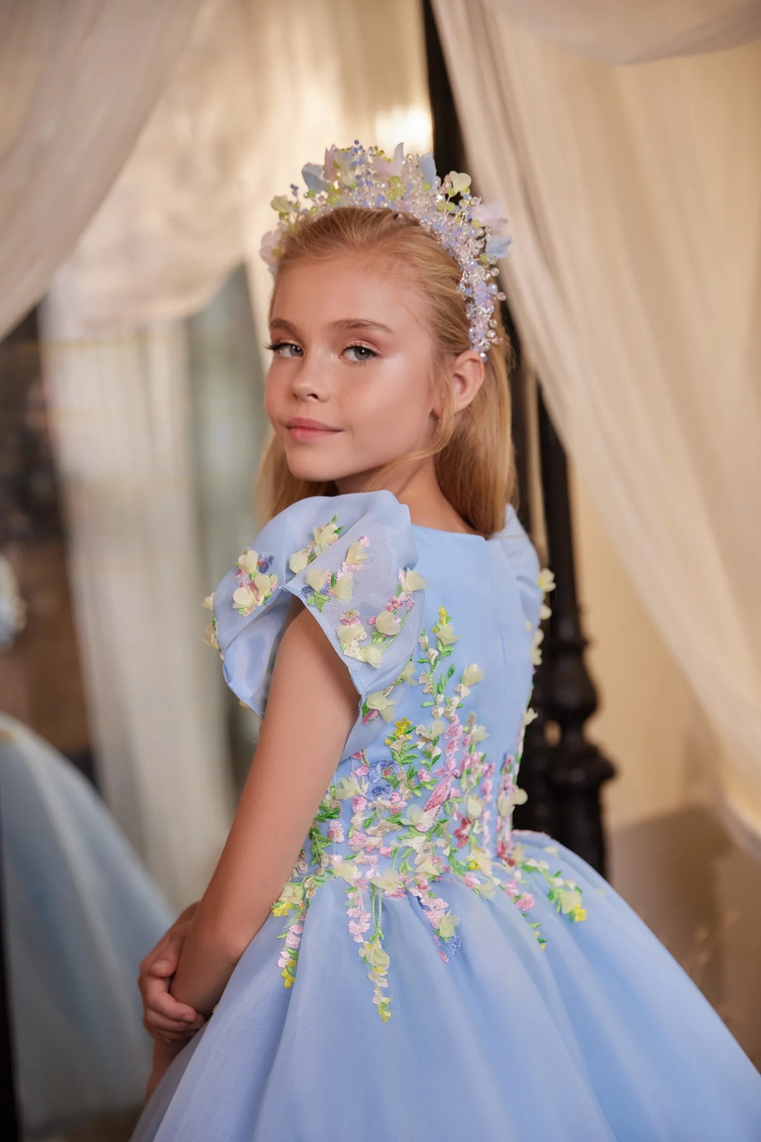 Side angle of embroidered princess dress with 3D flowers