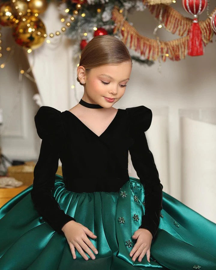 Side view of holiday flower girl dress in emerald green with layered skirt.