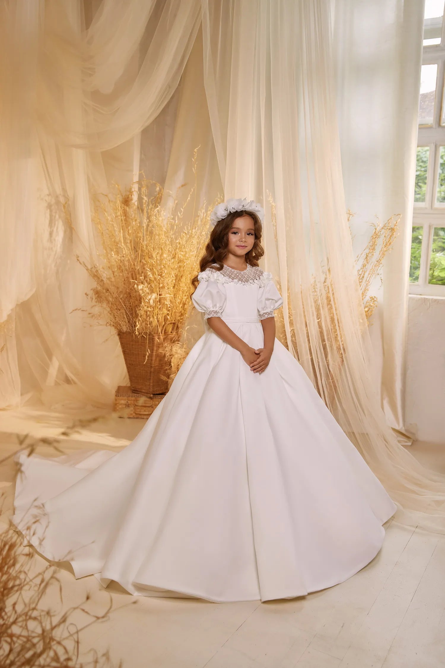 Satin flower girl gown with puff sleeves and a luxurious finish.