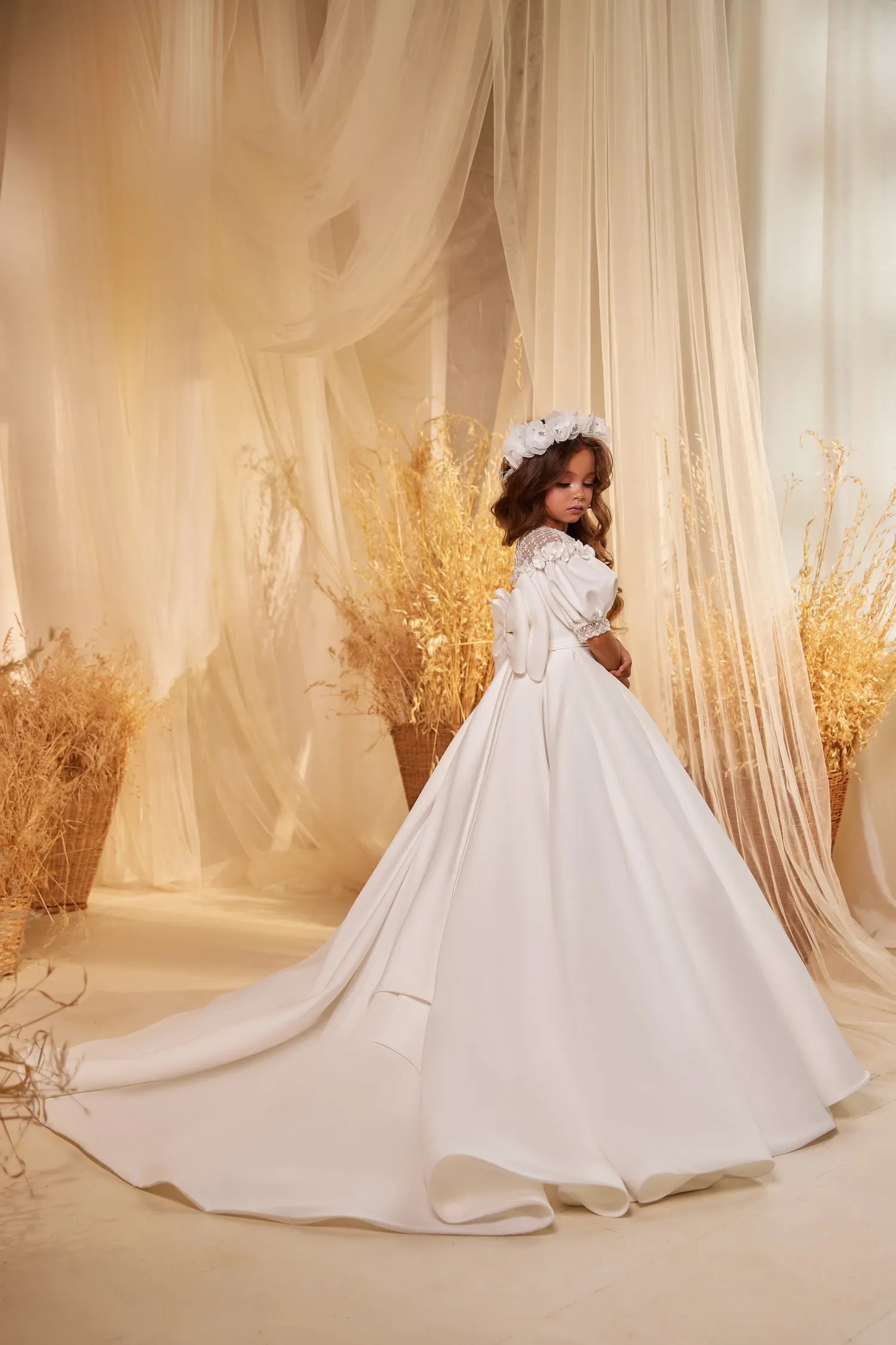 Back of the satin flower girl gown with a flowing train and buttons.