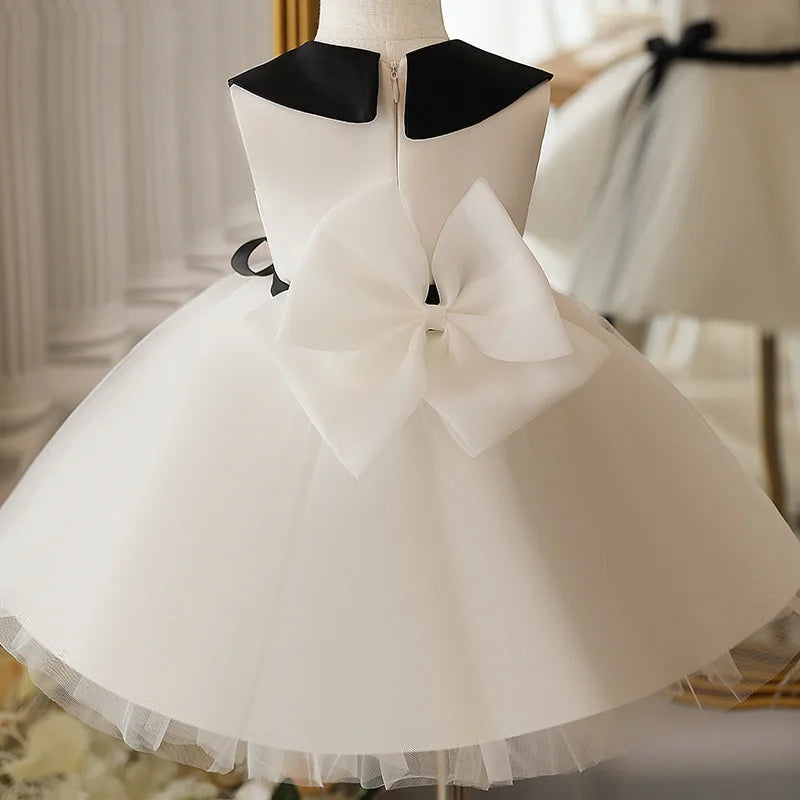 Back view of Ivory Tulle Dress with Peter Pan Collar – classic tulle dress with bow detail