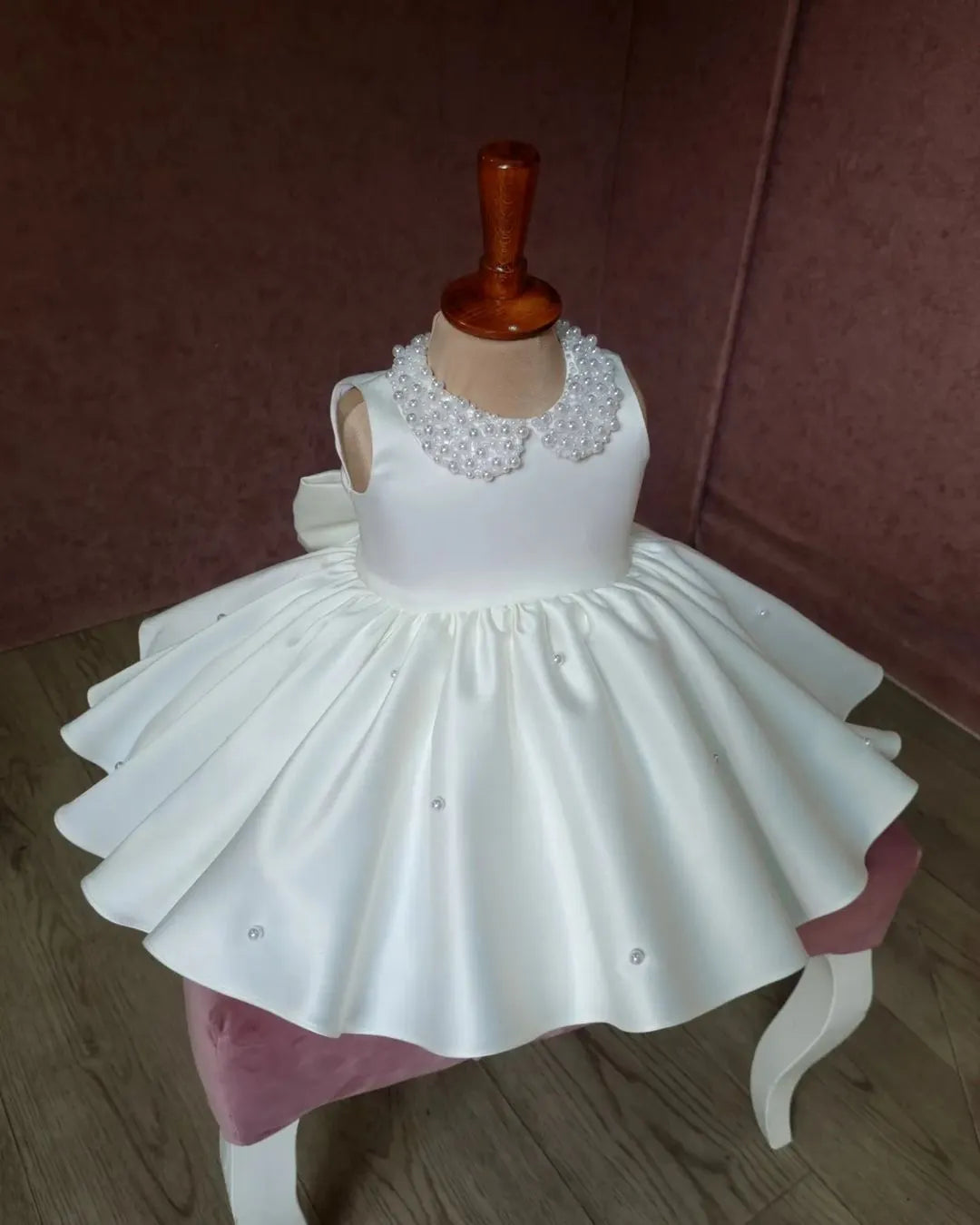 Front puffy view of a white satin girls' dress showcasing a simple and refined design, ideal for formal events.