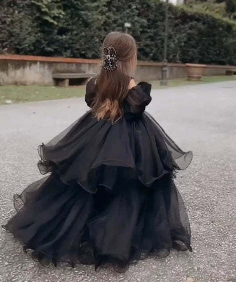 Back view of elegant black organza flower girl dress with layered skirt.