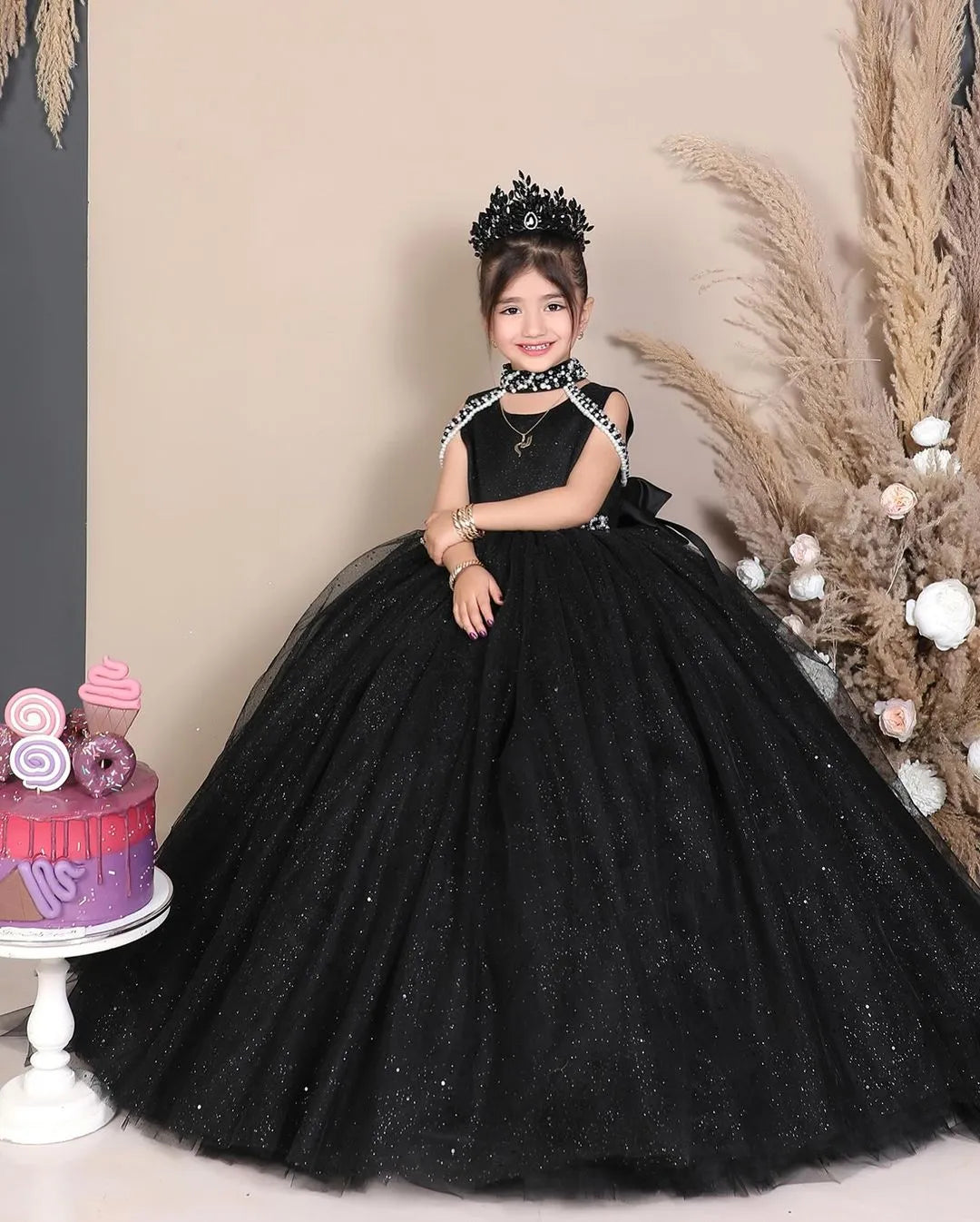  Front view of a black sparkling princess tulle gown for girls, featuring layers of glittery tulle for a magical, elegant look.