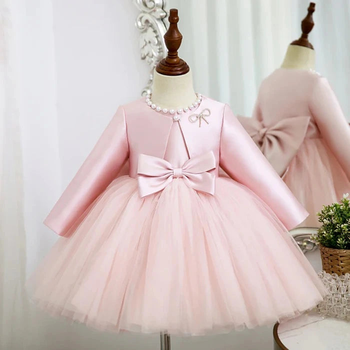 Front view of enchanting pink princess birthday dress with double bow and matching satin coat.