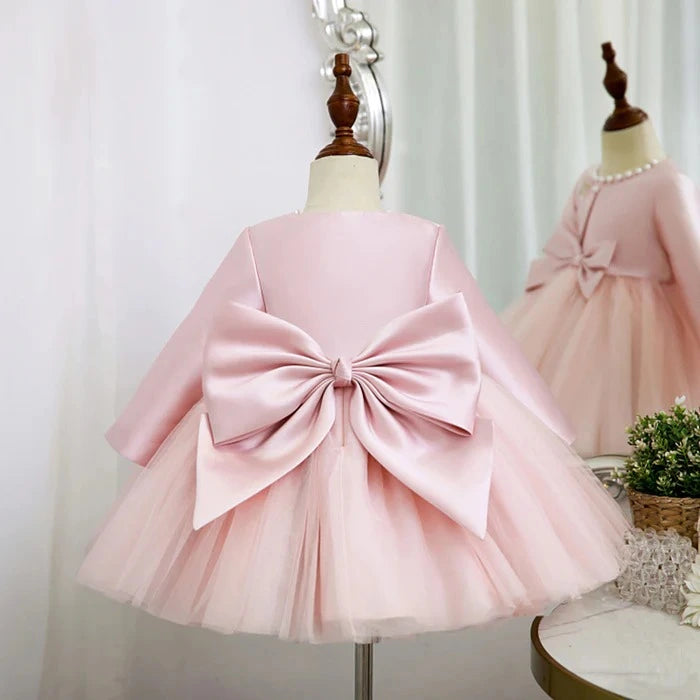 Back view of pink dress with layered tutu and satin coat, perfect for holidays.