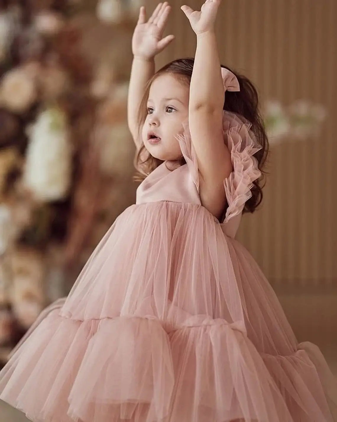 Side view of pink ruffled sleeve dress for toddler girls, perfect for special occasions.