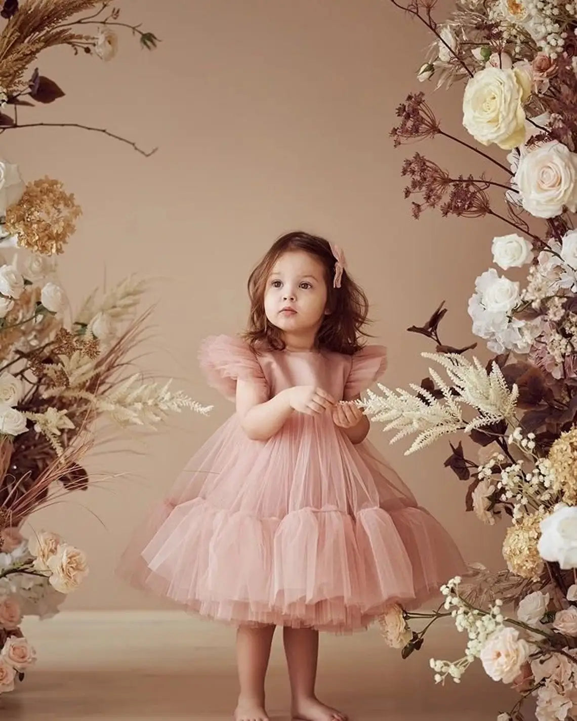 Front view of blush pink ruffle sleeve tulle dress for toddlers.