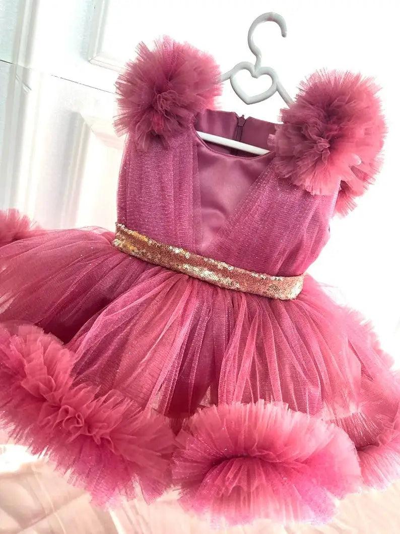 Side view of a girls’ dusty rose tutu dress with layered tulle and a shimmering sequin belt, perfect for special occasions.