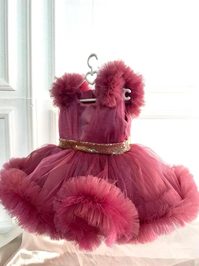 side view of sequin belt detail on a dusty rose princess tutu dress, highlighting intricate sparkles and tulle fabric.