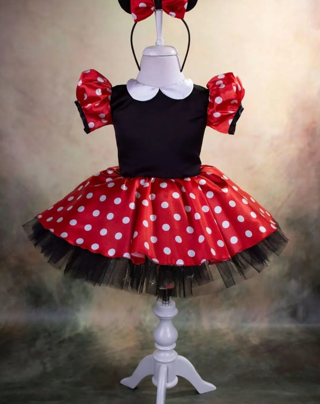 Front view of a Mickey Mouse-themed dress for girls, featuring playful Mickey details and a stylish bow.